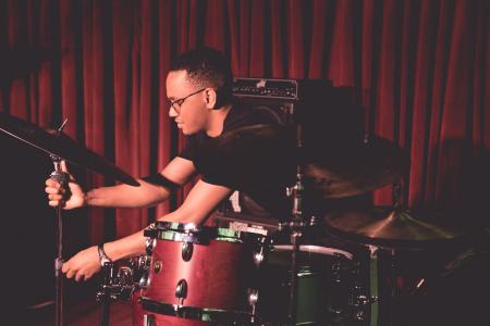 Jeremy Dutton adjusting drum kit