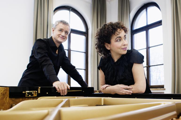 Yaara Tal and Andreas Groethuysen lean on an open piano