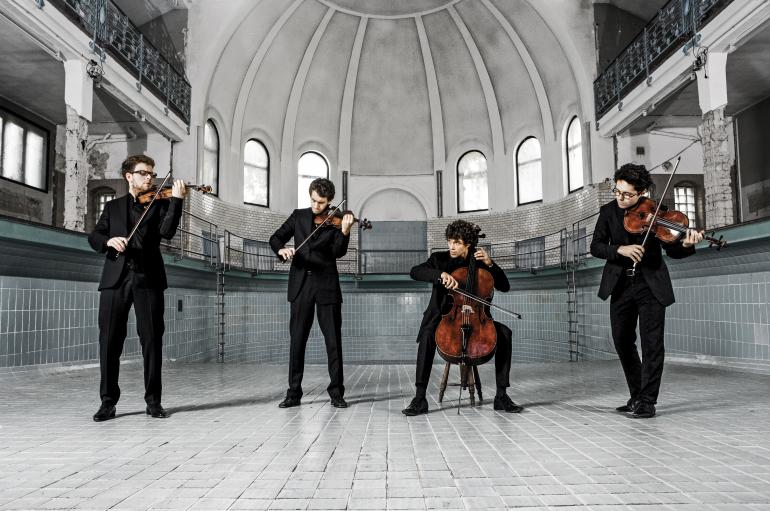Vision String Quartet performing with instruments