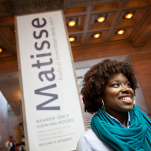 A female student stands outside a Matisse exhibit in Chicago.
