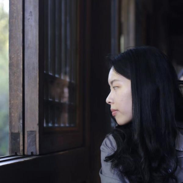 A picture of Ziyi looking thoughtfully out a window