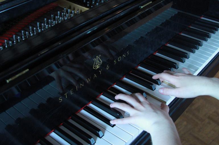 close-up of hands on a piano keyboard