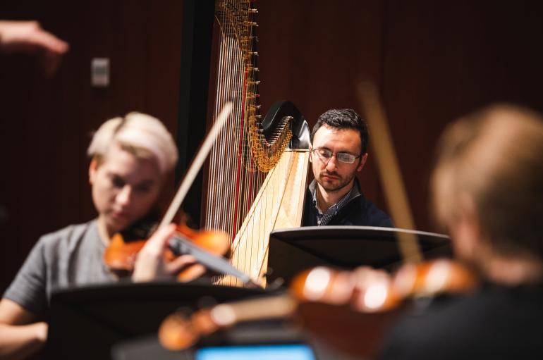 Violinist Maeve Feinberg and harpist Ben Melsky in rehearsal for the Grossman Ensemble