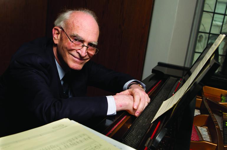 Philip Gossett sitting at a piano