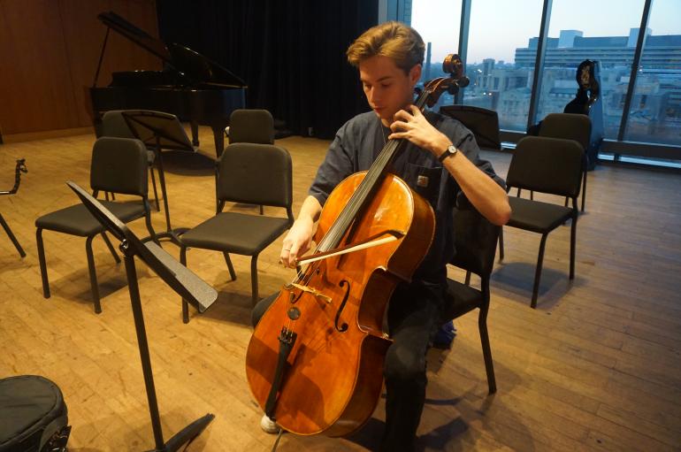 A man playing cello