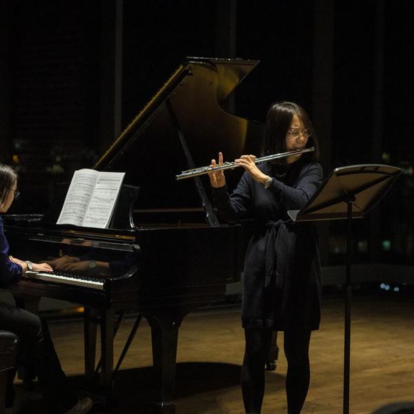 Chamber music duo of piano and flute performing 