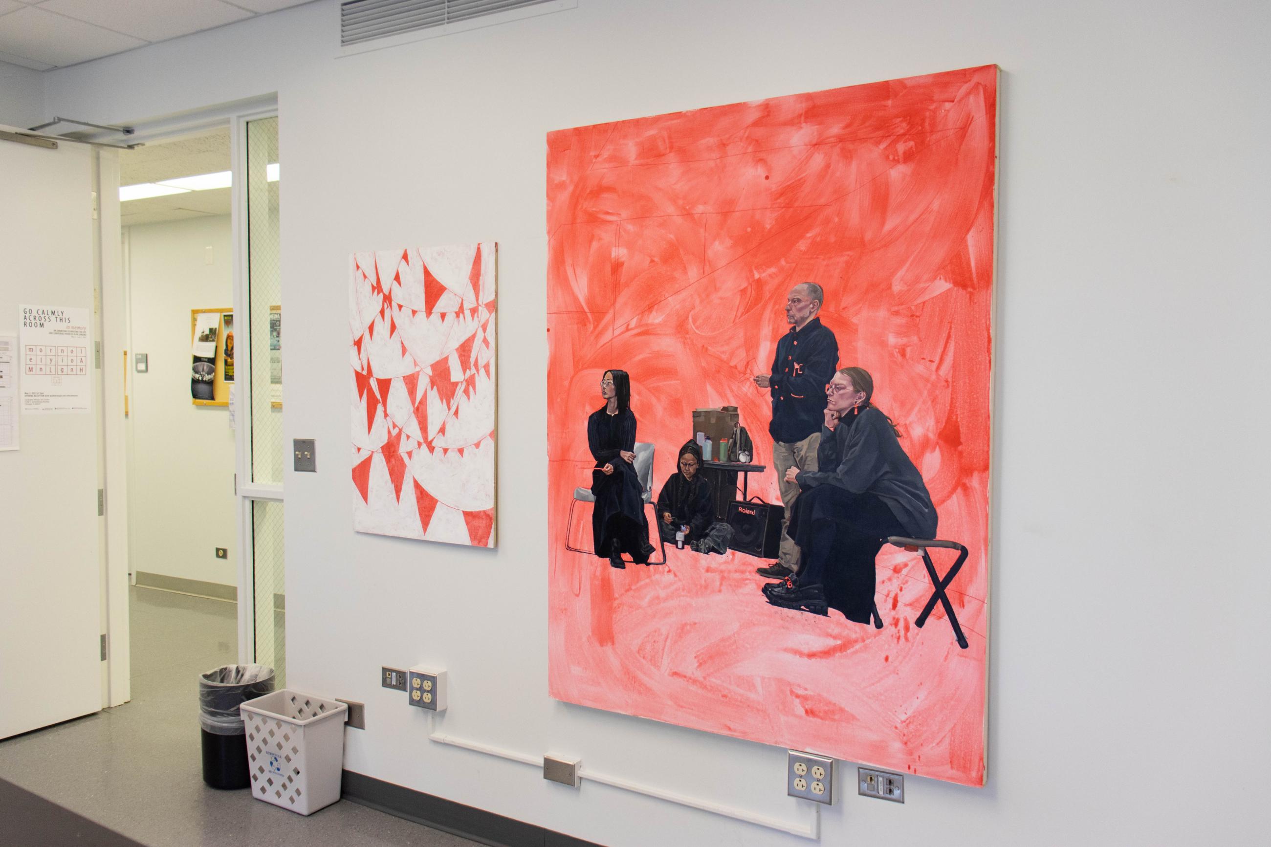 At left, a painting of criss-crossing flag pennants on a white background. At right, view of a group of people gathered at an art crit